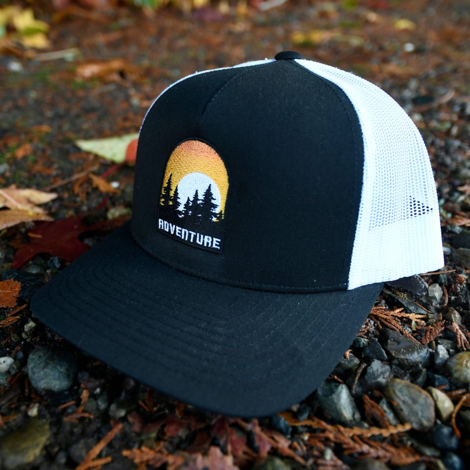 ADVENTURE SUN SETTING BEHIND TREES | CURVED BILL TRUCKER